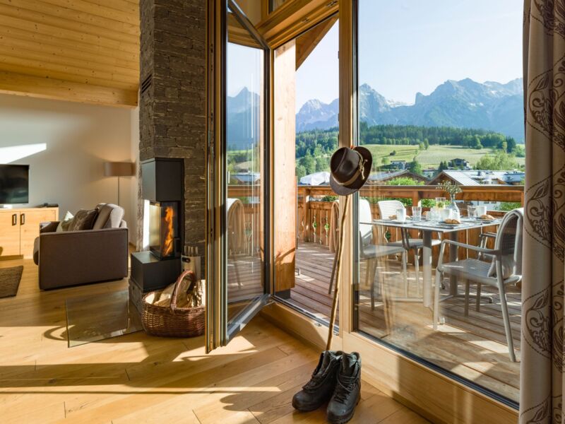 Hotelresort Maria Alm - Alpin Lodges - großzügiger Wohnraum mit Kaminofen im Penthouse